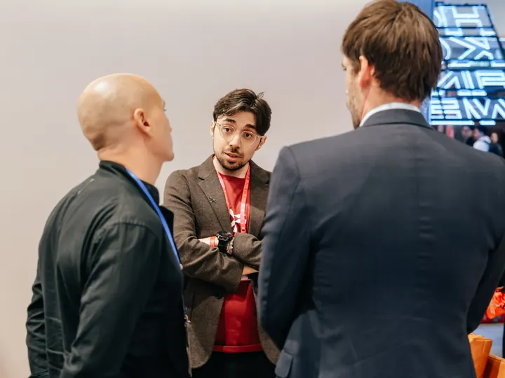 The FinoverseAI team speaking with attendees